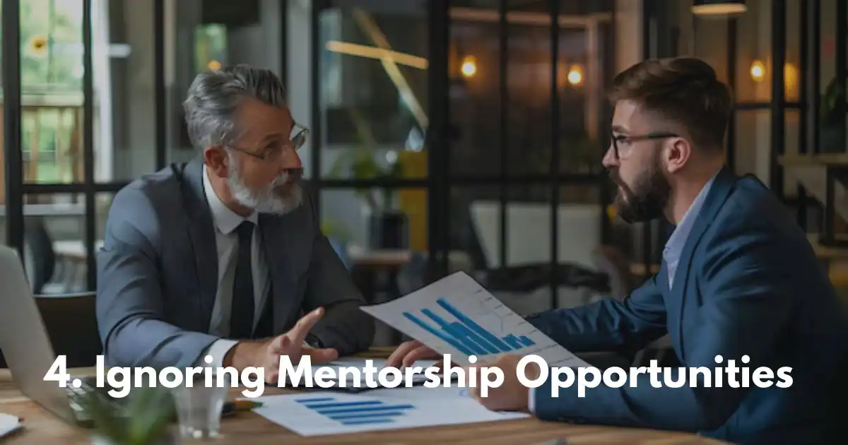 Two men in suits discussing charts, emphasizing mentorship neglect