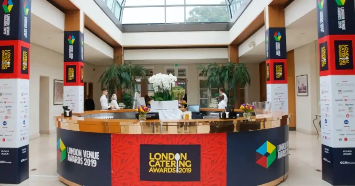 Elegant reception setup at the London Catering Awards 2019 with branded decor and staff