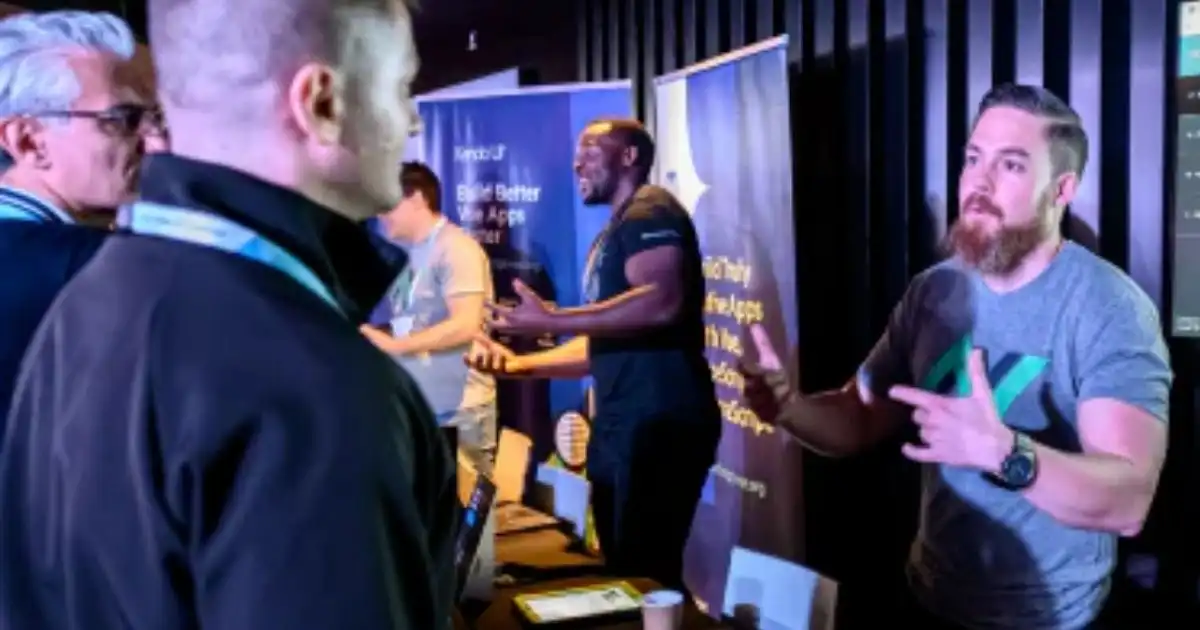 People engaging in conversations at a tech event or business expo booth