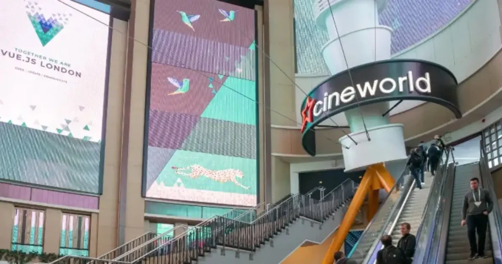 Modern shopping mall interior with large digital screens and Cineworld signage