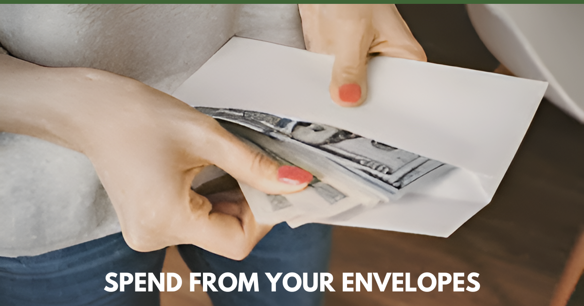 Person pulling cash from a white envelope while wearing casual clothes and coral nail polish.