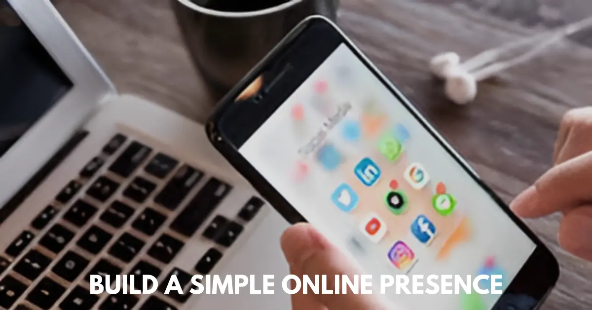 Hand holding smartphone with social media icons open, laptop and coffee nearby.