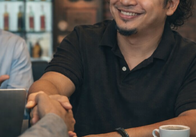 sam shake hands image with the clients