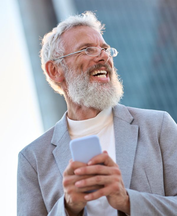 happy old professional business man holding phone 2023 11 27 05 12 40 utc.jpg